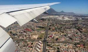 View from airplane window overlooking Cape Town city with Lion's Head mountain top.in the background.