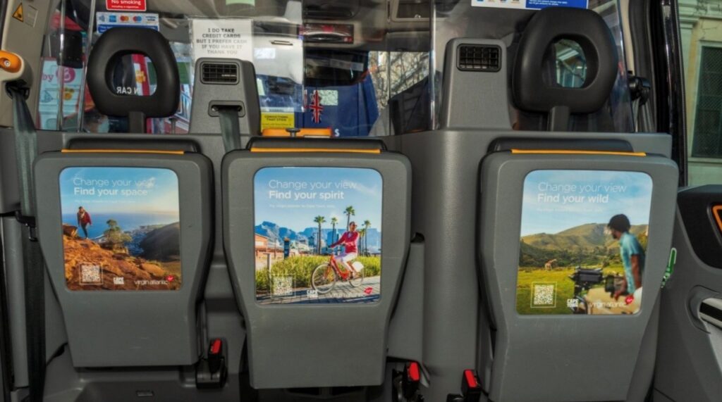 A cab in London featuring the Virgin Atlantic advertising, including a QR code linking directly to flight bookings.
